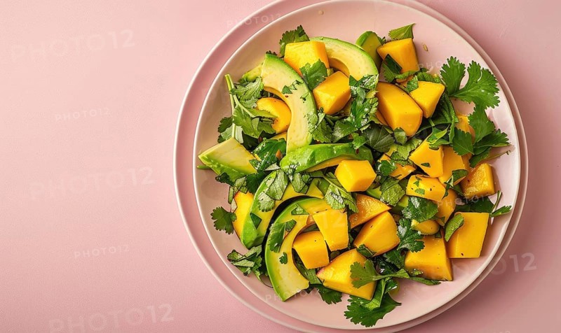 Avocado and mango salad with cilantro on a pastel pink plate AI generated