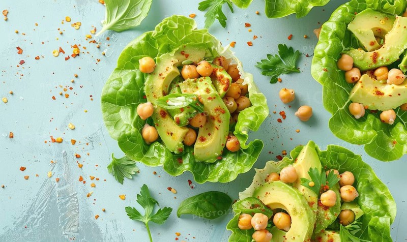 Avocado and chickpea salad in lettuce cups on a light blue background AI generated