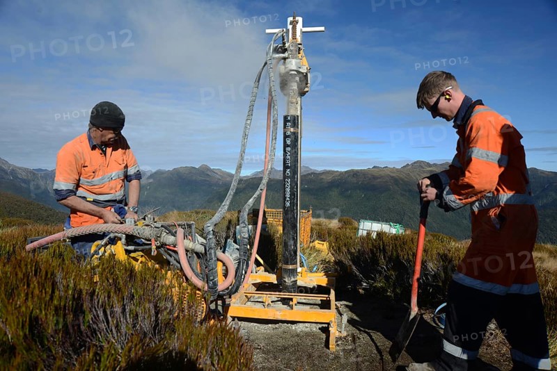 Drillers operate a portable drilling rig to sink a 10 metre hole on the summit of Mount Morgan overlooking the Haupiri Valley, West Coast, New Zealand on May 7, 2024. The hole will be used for seismic GPS monitoring instruments to measure movement along the Alpine Fault which runs near the base of the mountain. All drilling equipment including an air compressor, generator and drilling rig was flown to the summit by helicopter