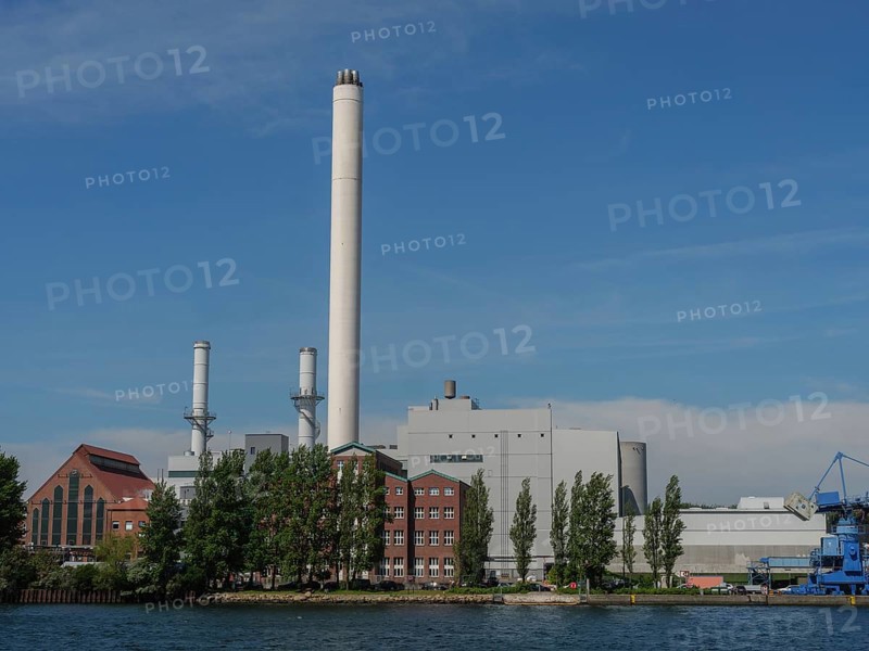Industrial plant with chimneys and red brick buildings on the waterfront under a clear sky, Flensburg, Schleswig-Holstein, Germany, Europe