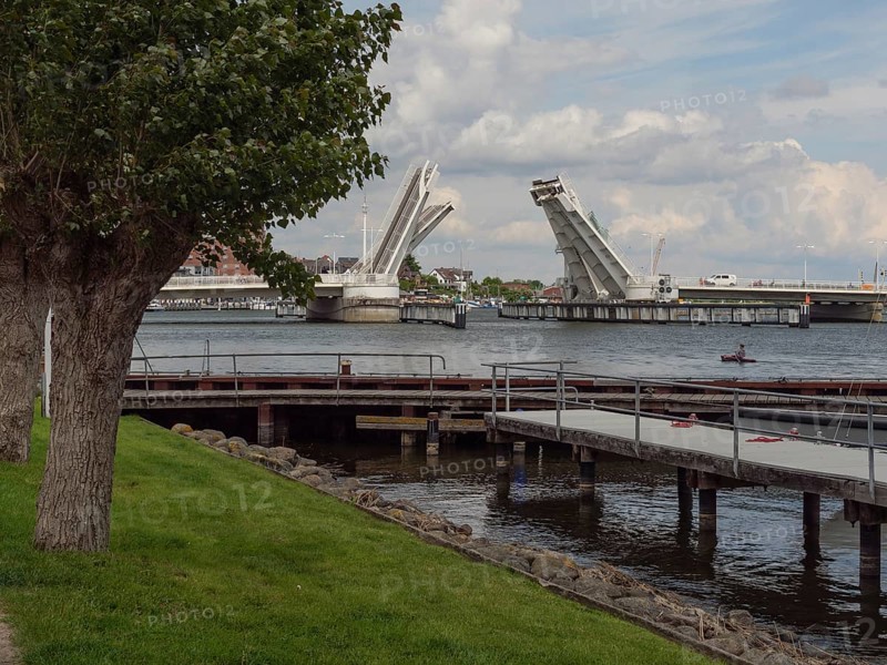 Rising bascule bridge over a harbour under a partly cloudy sky, Kappeln, Schleswig-Holstein, Germany, Europe