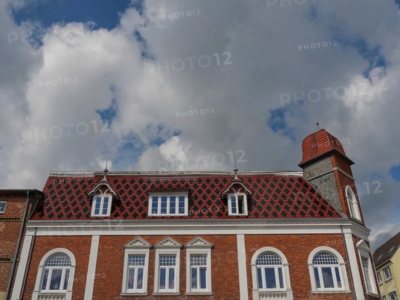 Historic building with red roof tiles under a cloudy sky, Kappeln, SChleswig-Holstein, Germany, Europe