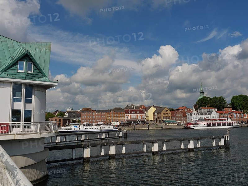 View of the town and harbour with boats and a bridge under a cloudy sky, Kappeln, Schleswig-Holstein, Germany, Europe