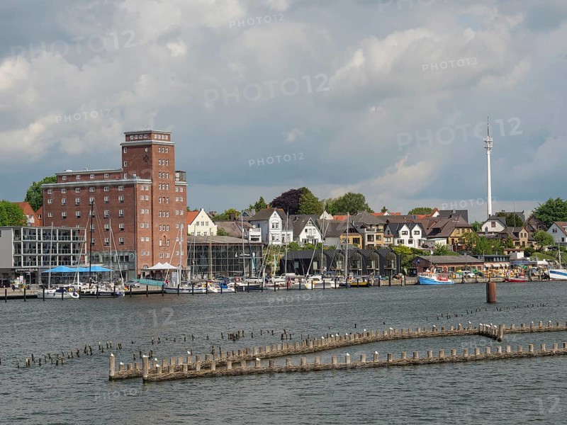 Town view with various buildings and boats on the waterfront under a cloudy sky, Kappeln, Schleswig-Holstein, Germany, Europe
