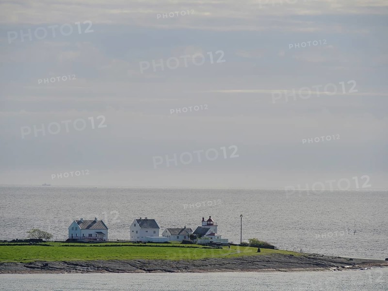 An island with few houses surrounded by the sea under a cloudy sky, Stavanger, Norway, Europe