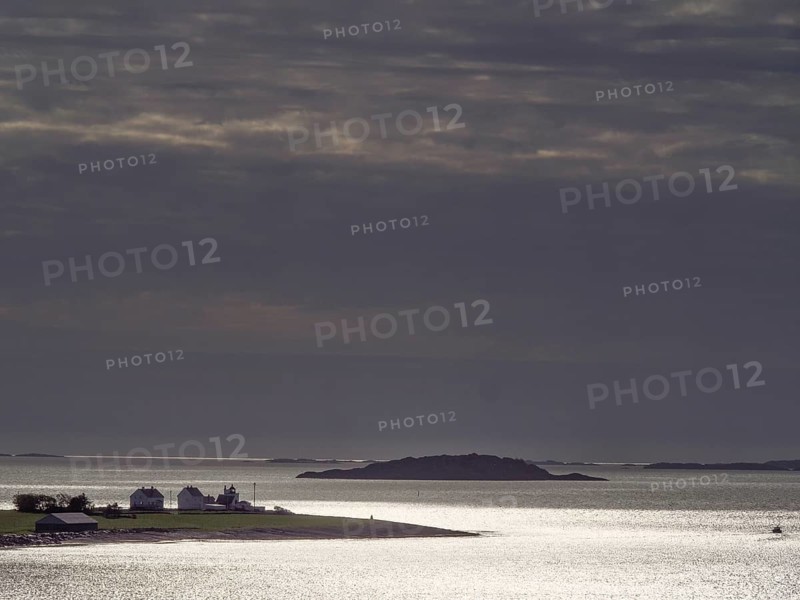 Twilight over a tranquil coastal landscape with silhouetted islands, Stavanger, Norway, Europe