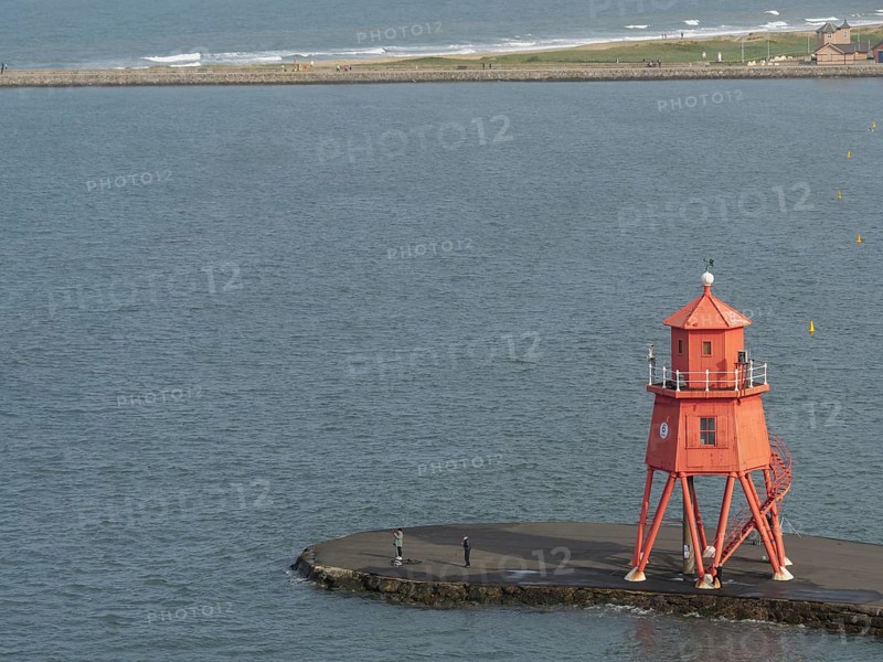 Red lighthouse on a pier, on a calm day with a wide sea view, Newcastle, England, Great Britain