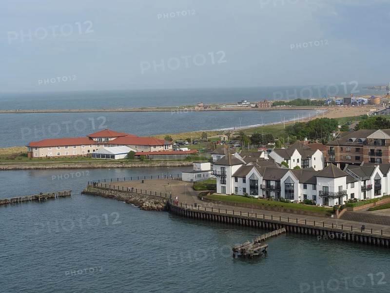 Stretch of coastline with several modern houses and views of the tranquil seascape, Newcastle, England, United Kingdom, Europe