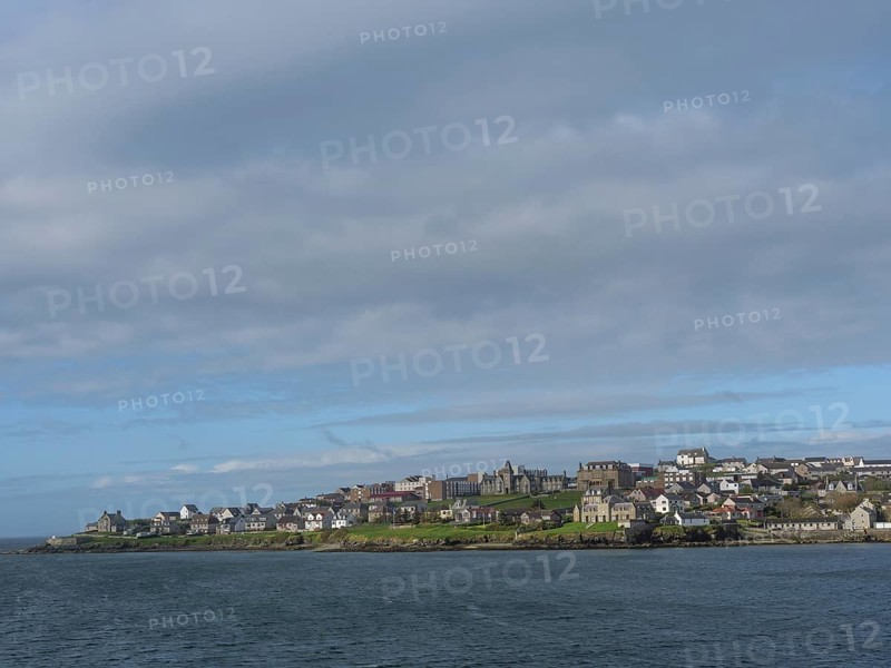 Coastal landscape with houses under cloudy sky and neighbouring sea, Lerwick, Shetlands, Scotland, United Kingdom, Europe