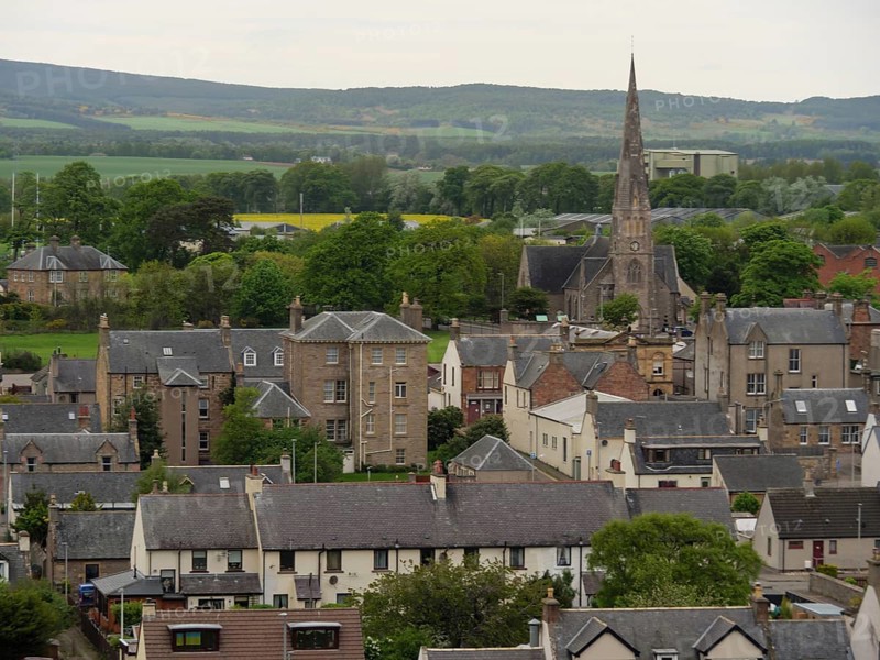 A village with a church and houses surrounded by green countryside and hills, inverness, Scotland, United Kingdom, Europe
