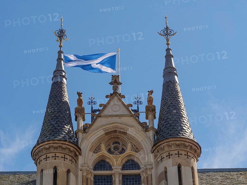 Close-up of a castle with Scottish flag, distinctive towers and detailed architecture under a clear sky, inverness, Scotland, United Kingdom, Europe