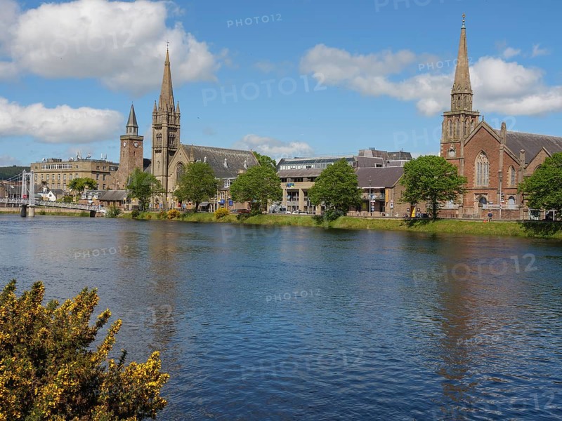 A cosy riverside town with striking church buildings and trees under a partly cloudy sky, inverness, Scotland, United Kingdom, Europe