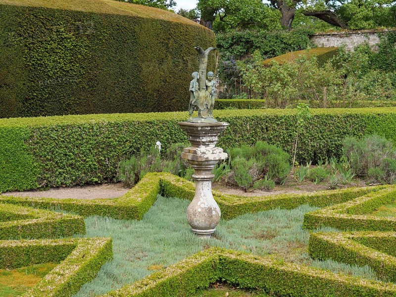 A garden landscape with manicured hedges, symmetrical shapes and a central sculpture, inverness, Scotland, Great Britain