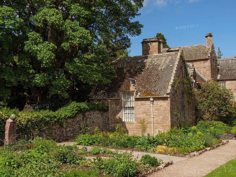 Small stone house in garden with trees and sunny weather, inverness, Scotland, United Kingdom, Europe