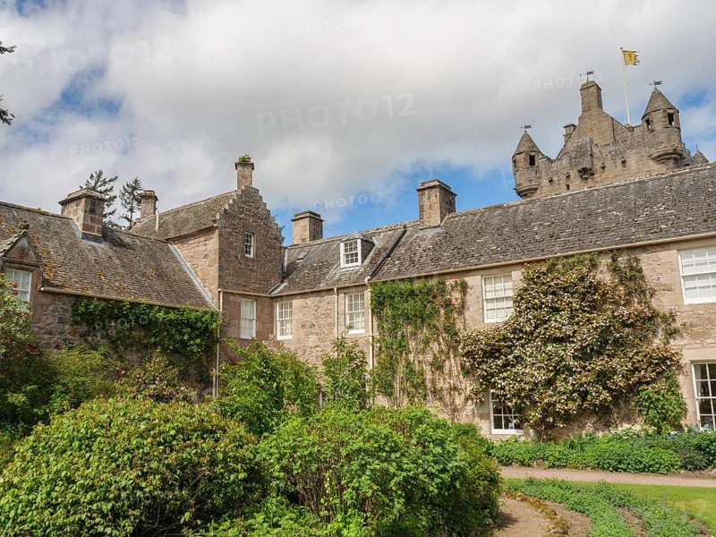 Historic stone house with climbing plants and garden, part of a larger castle, inverness, Scotland, Great Britain
