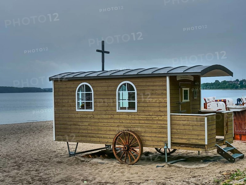Wooden wagon on a gloomy beach, close to the water, surrounded by beach chairs, Eckernförde, SChleswig-Holstein, Germany, Europe