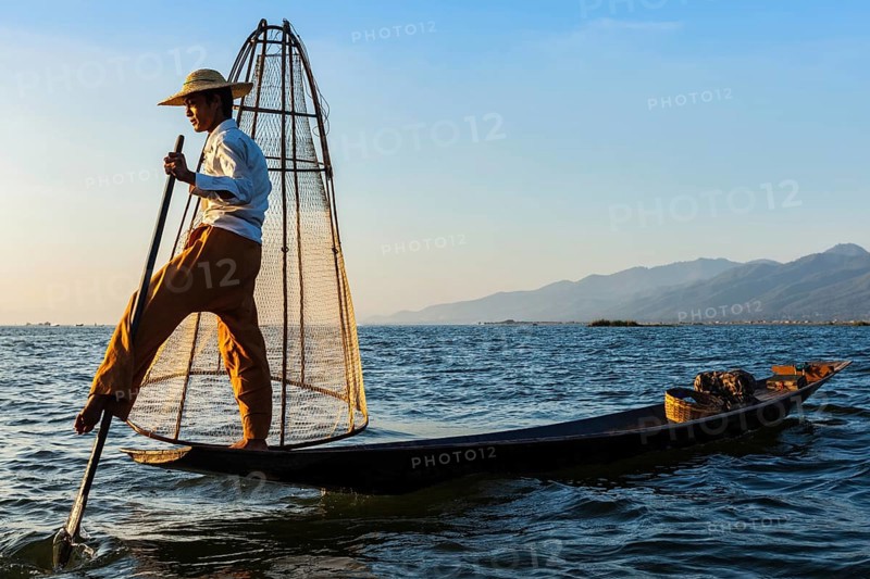 Myanmar travel attraction landmark, Traditional Burmese fisherman at Inle lake, Myanmar famous for their distinctive one legged rowing style