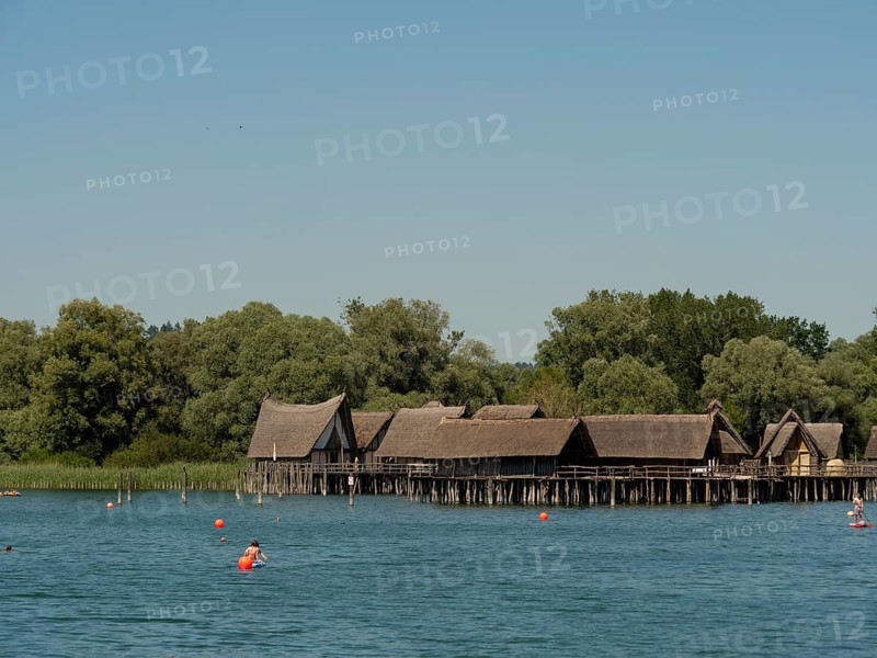 A historic pile-dwelling village on a calm lake with several buoys, Meersburg, Lake Constance, Germany, Europe