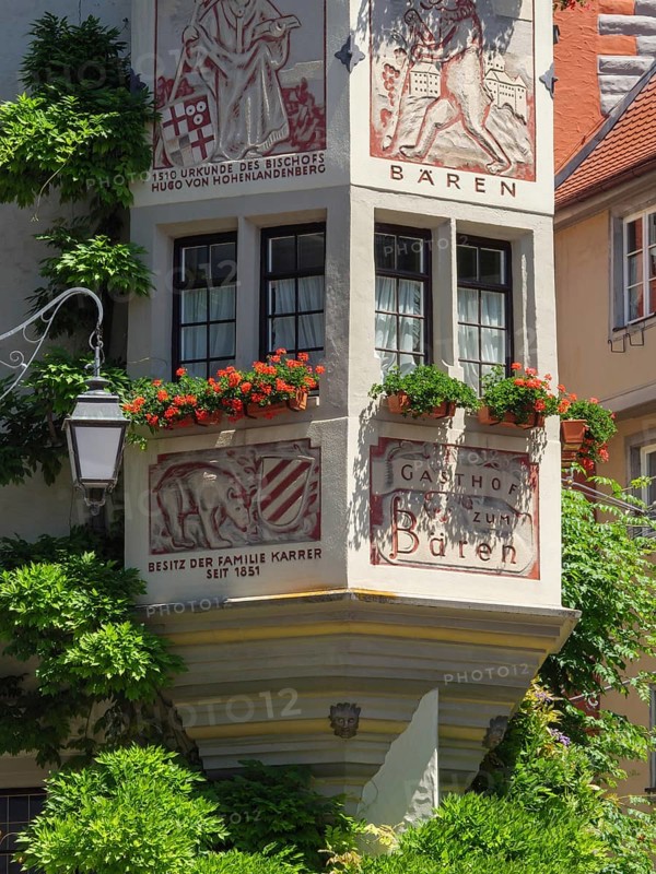 A decorated half-timbered house with murals and red geraniums in full bloom, Meersburg, Germany, Europe