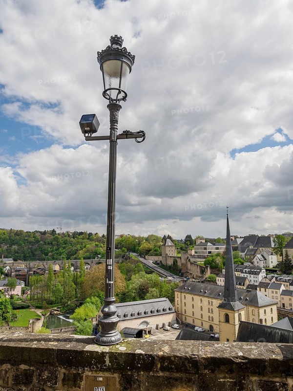 Urban landscape with modern elements, clouds in the sky and a historic lantern, Luxembourg City, Luxembourg, Europe