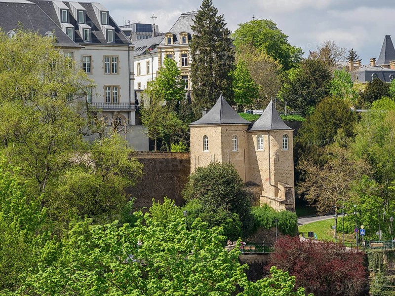 Historic buildings with towers, surrounded by green trees and a park. Springtime atmosphere, Luxembourg City, Luxembourg, Europe