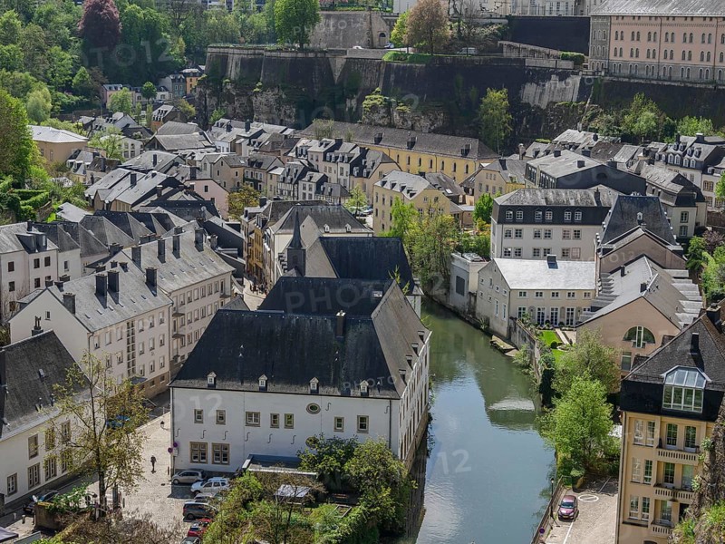 Old town scene with narrow houses, a river and wooden hills in the background, Luxembourg City, Luxembourg, Europe