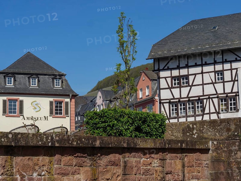 Historic buildings, including a museum and a half-timbered house, in sunny weather, Saarburg, germany