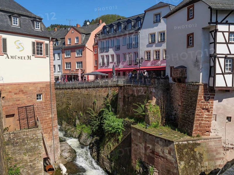 A picturesque old town with half-timbered houses and cafés along a small waterfall, Saarburg, Germany, Europe