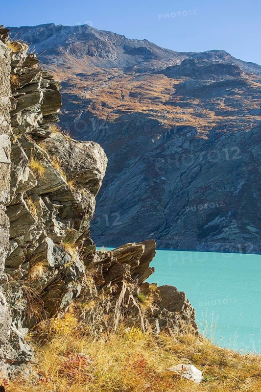 Turquoise lake in the middle of a rocky mountain landscape in autumn, Saas Fee, Switzerland, Europe