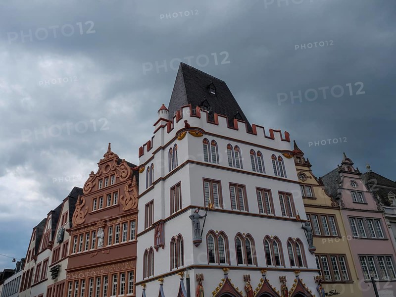 Row of historic buildings with ornate facades and Renaissance influences under a cloudy sky, trier, germany
