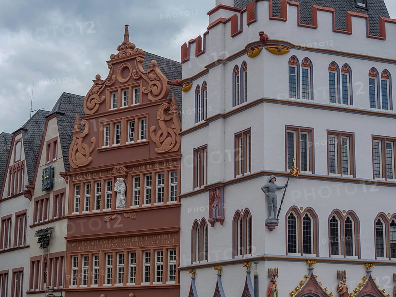 Row of historic buildings with detailed facades and Renaissance influences under a cloudy sky, trier, germany