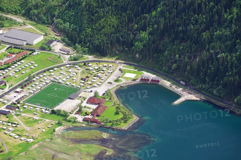 Top view of a campsite with football pitch and neighbouring lake in the middle of a forest, view from Hoven, Loen, Nordfjord, Fjordland, Norway, Europe
