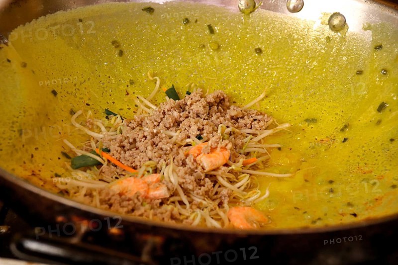Close up of banh xeo or vietnamese crepe being cooked in a wok, authentic traditional Vietnamese street food