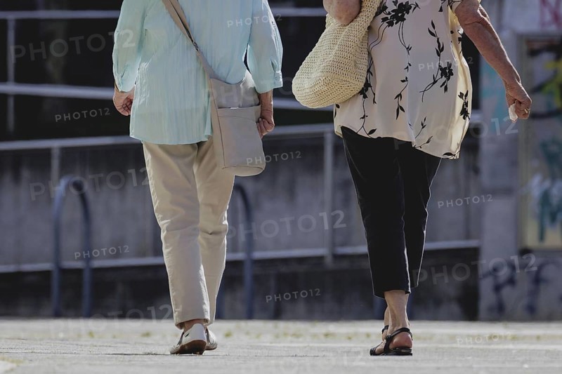 Two older woman walking together, taken in Berlin, 07/08/2024
