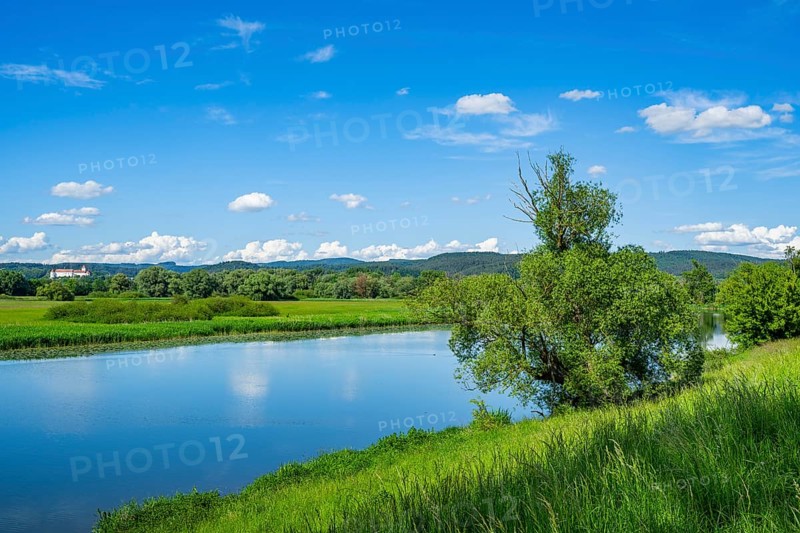 Landscape of Danubia river with reflection of the landscape and Clouds, Castle of Wörth an der Donau in the background, Upper Palatinate, Bavaria, Germany, Europe