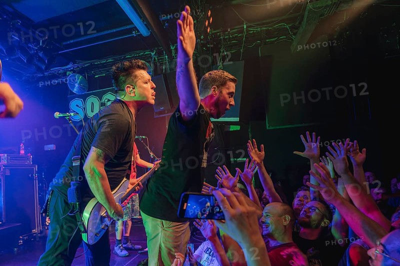 Chris Demakes, singer and guitarist of Less Thank Jake, and fan stage-diving live at Berlin SO36 on 31/07/2024