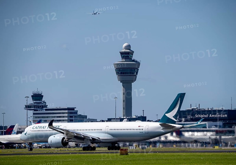 Aircraft at Amsterdam Schiphol Airport, taking off on the Aalsmeerbaan, 18L/36R, Cathay Pacific Airbus A350-1041, air traffic control tower, terminal, Netherlands