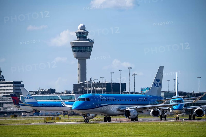 Aircraft at Amsterdam Schiphol Airport, on the taxiway for take-off on the Aalsmeerbaan, 18L/36R, air traffic control tower, terminal, Netherlands