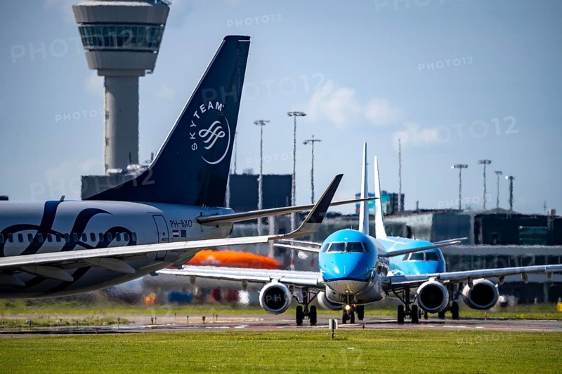 Aircraft at Amsterdam Schiphol Airport, on the taxiway for take-off on the Aalsmeerbaan, 18L/36R, air traffic control tower, terminal, Netherlands