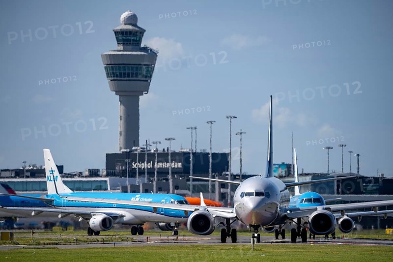Aircraft at Amsterdam Schiphol Airport, on the taxiway for take-off on the Aalsmeerbaan, 18L/36R, air traffic control tower, terminal, Netherlands