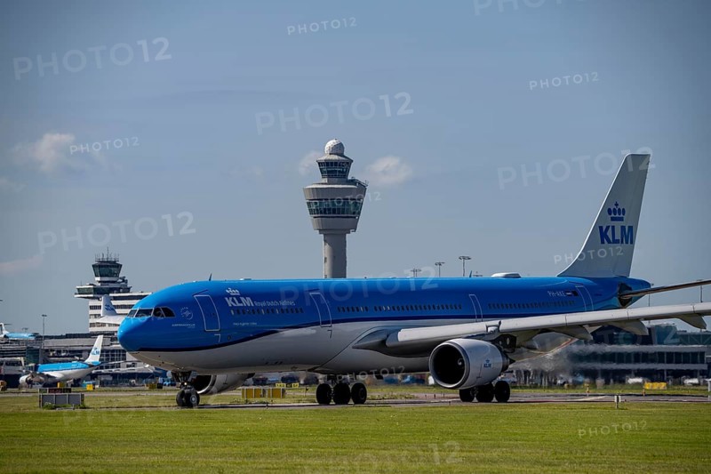 Aircraft at Amsterdam Schiphol Airport, on the taxiway for take-off on the Aalsmeerbaan, 18L/36R, KLM Airbus A330-303, air traffic control tower, terminal, Netherlands