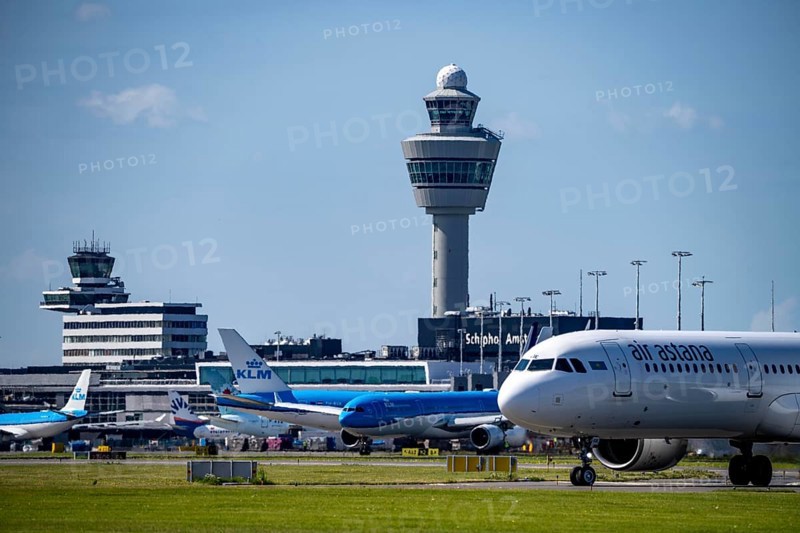 Aircraft at Amsterdam Schiphol Airport, on the taxiway for take-off on the Aalsmeerbaan, 18L/36R, Air Astana Airbus A321, air traffic control tower, terminal, Netherlands