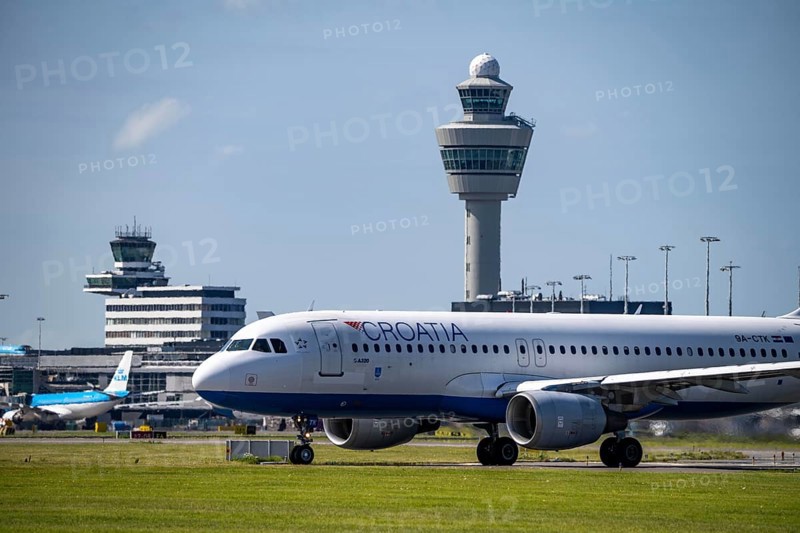 Aircraft at Amsterdam Schiphol Airport, on the taxiway for take-off on the Aalsmeerbaan, 18L/36R, Croatia Airbus A320, air traffic control tower, terminal, Netherlands