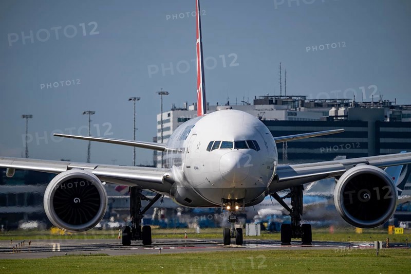 Aircraft at Amsterdam Schiphol Airport, on the taxiway for take-off on the Aalsmeerbaan, 18L/36R, Turkish Airlines Boeing 777-3F2, air traffic control tower, terminal, Netherlands