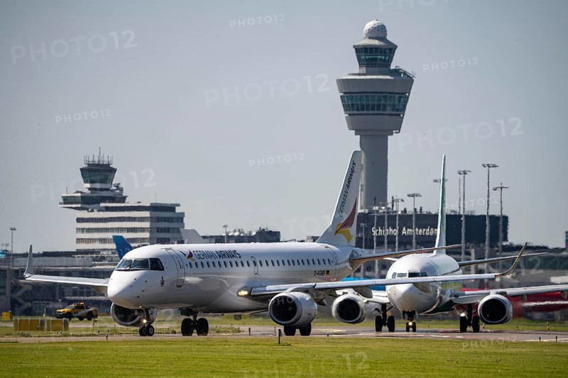 Aircraft at Amsterdam Schiphol Airport, on the taxiway for take-off on the Aalsmeerbaan, 18L/36R, air traffic control tower, terminal, Netherlands