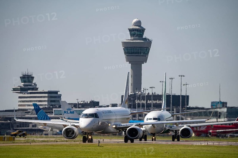 Aircraft at Amsterdam Schiphol Airport, on the taxiway for take-off on the Aalsmeerbaan, 18L/36R, air traffic control tower, terminal, Netherlands