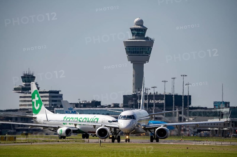 Aircraft at Amsterdam Schiphol Airport, on the taxiway for take-off on the Aalsmeerbaan, 18L/36R, air traffic control tower, terminal, Netherlands