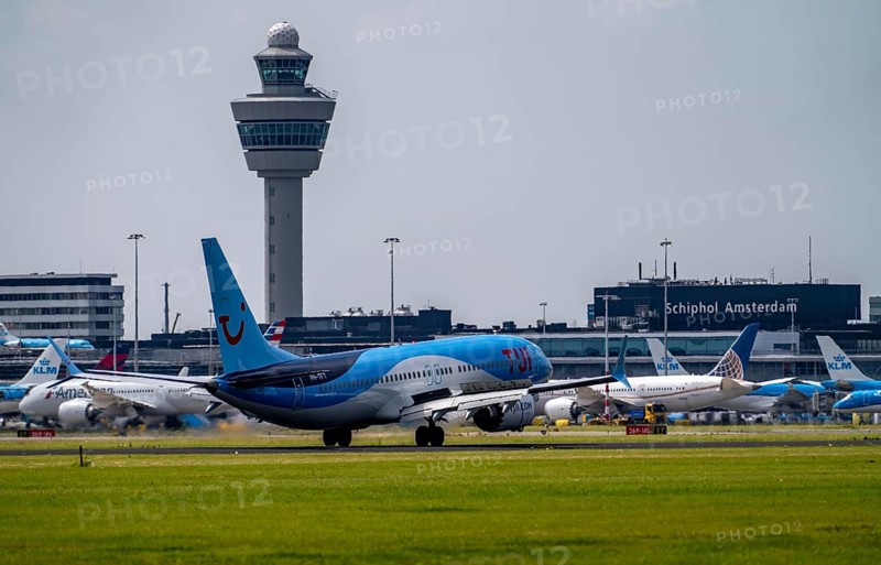 TUI Boeing 737-Max8, aircraft landing at Amsterdam Schiphol Airport, Buitenveldertbaan, 09/27, air traffic control tower, terminal, Netherlands