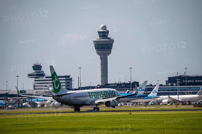 Transavia Boeing 737-800, aircraft landing at Amsterdam Schiphol Airport, Buitenveldertbaan, 09/27, air traffic control tower, terminal, Netherlands