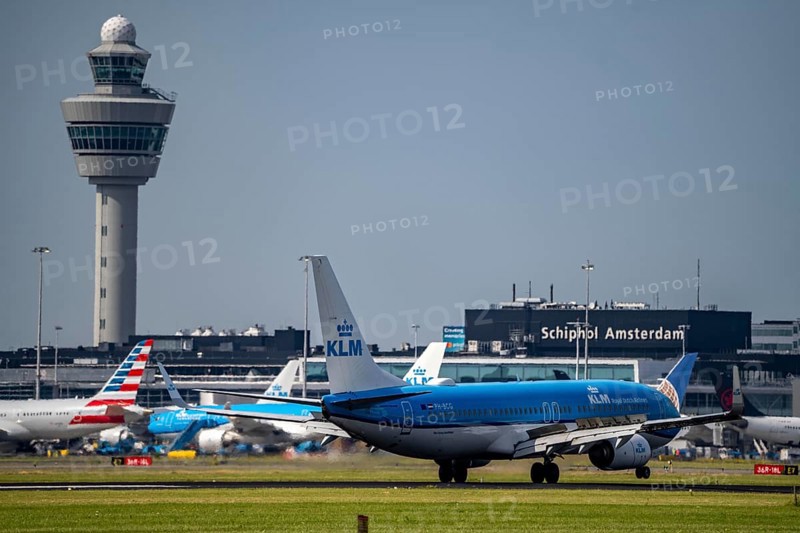 KLM Boeing 737-800, aircraft landing at Amsterdam Schiphol Airport, Buitenveldertbaan, 09/27, air traffic control tower, terminal, Netherlands